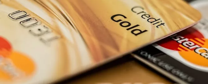 Two MasterCards and a Visa card stacked on top of one another; one card has its last four numbers visible and says "Credit - Gold". Fraud prevention is a concern for anyone doing credit repair services.