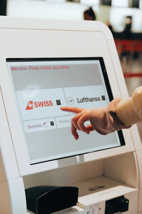 person using self check in kiosk - travel agents often struggle without protection against chargebacks in the travel industry